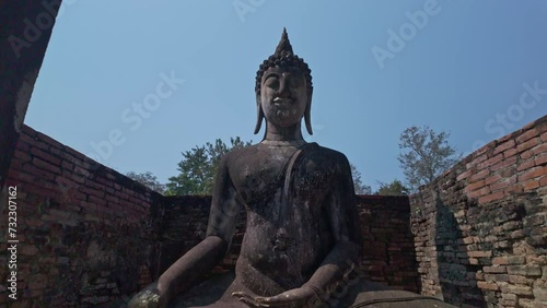 .Beautiful statue of Buddha and the ruins of buildings in historical sites built in the Sukhothai period in Wat Sri Chum, Sukhothai Province. .Phra Ajana, The beautiful Buddha statue in the  church. . photo