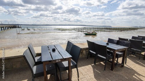 bar restaurant tables on the tip of Cap Ferret at low tide with oyster farm in Lege in Gironde france