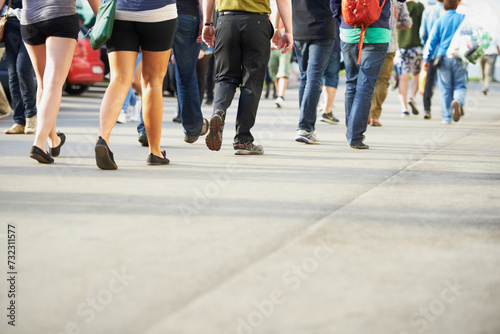 Crowd, legs and people on road walking on holiday vacation or weekend to travel or fun in city. Social, festival or shoes of community outdoors for group activity, event and commute in urban town