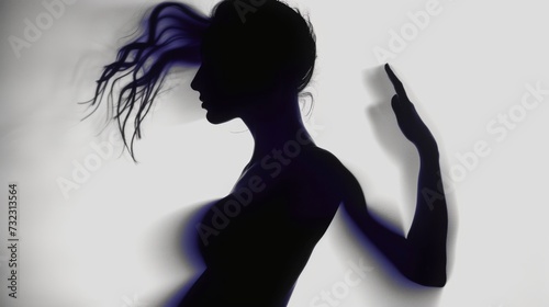 Female blurred silhouette on a grey background. Elegant outline of a woman in motion out of focus