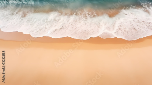 Sandy beach with light blue transparent water waves and sunlight, tranquil aerial beach scene