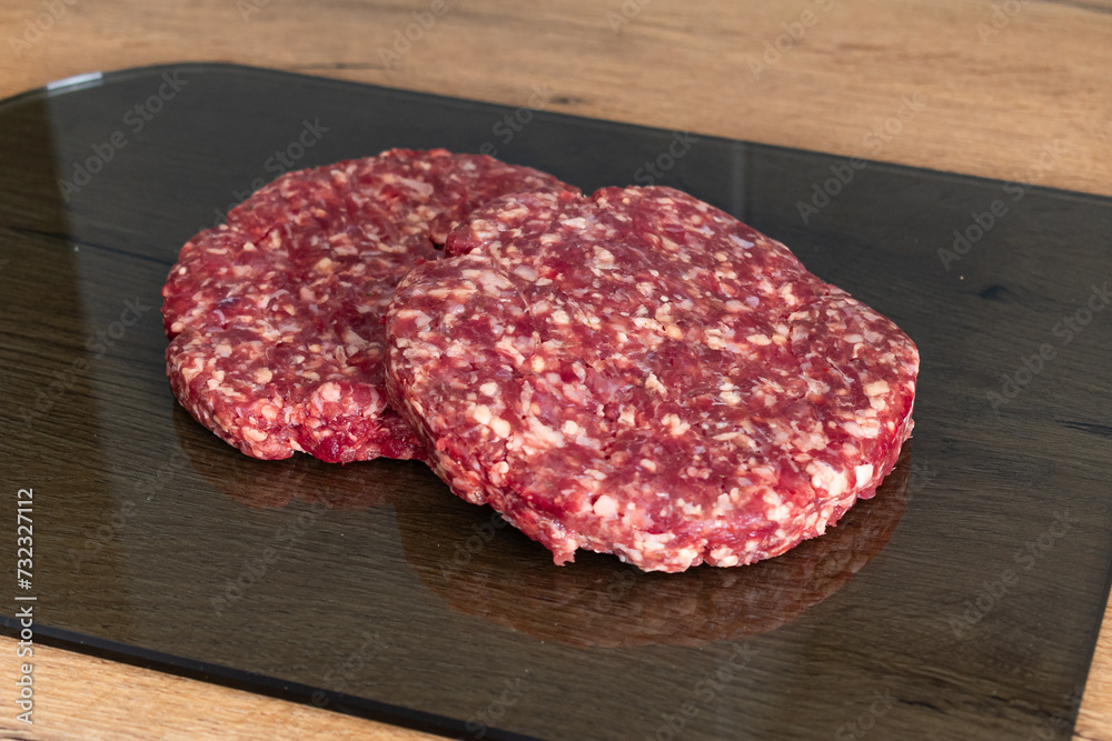 Beef cutlet for burger on cutting board Beef cutlet for burger on cutting board