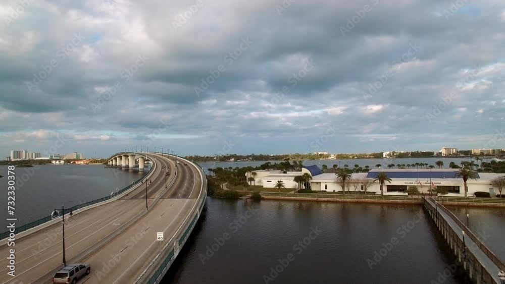 Aerial Forward Ascending Shot Of Cars Moving On Segmental Bridge Over River In City - Daytona Beach , Florida Aerial Forward Ascending Shot Of Cars Moving On Segmental Bridge Over River In City - Daytona Beach , Florida