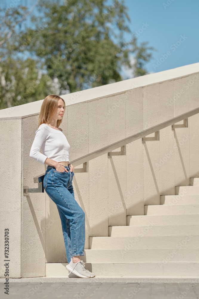 Woman standing on stairs in profile
