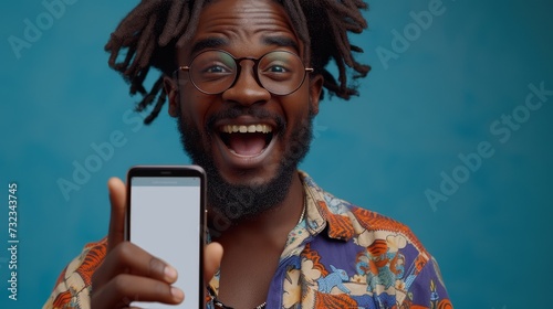The following recommendation is for a portrait of an enthusiastic black guy with a big smartphone with white blank screen in hand, pointing at the device and looking close to the camera. Gadget with