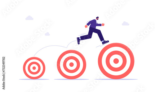 Businessman jumping up higher target career goals, aspiration and motivation to achieve bigger business target, advancement in career or business growth concept photo