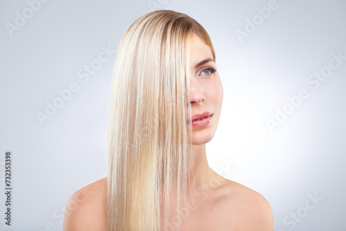 Straight hair, beauty and blonde woman in makeup, care or thinking isolated on a white studio background. Face, hairstyle and serious model in cosmetics, hairdresser and salon treatment for keratin