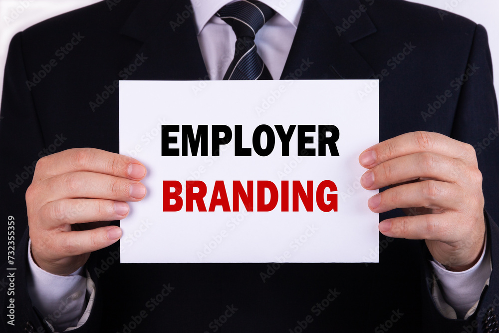 Businessman holding a card with text employer branding Businessman holding a card with text employer branding