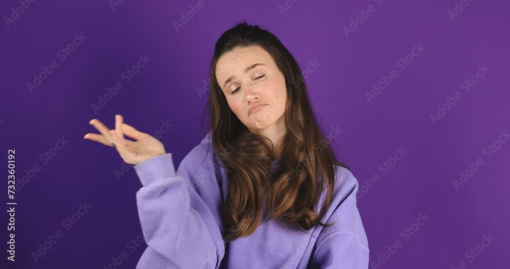 Pensive puzzled young girl thinking isolated on purple background in studio. Looking aside up put hand prop up on chin. Thoughtful woman agree, yes good idea, find a decision.