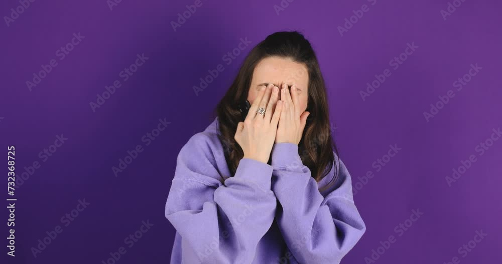 Angry woman watching sports on television sitting in front of tv. Anxious emotional female watching match on tv and yelling, nervous. Girl watch movie and worries, cover eyes, horror film on purple. Angry woman watching sports on television sitting in front of tv. Anxious emotional female watching match on tv and yelling, nervous. Girl watch movie and worries, cover eyes, horror film on purple.