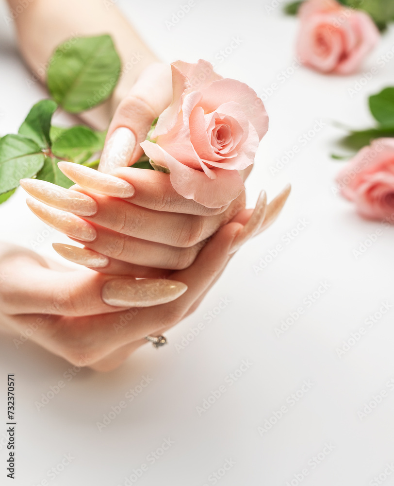 © Olena Rudo - Female Hands on a white background with beautiful pearl manicure.Hands on a brown background and beautiful pearl manicure