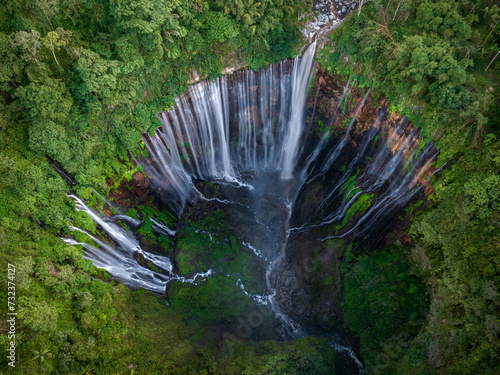 Aerial top view from above of Tumpak Sewu ,also known as Coban Sewu, 120m high waterfall in Malang regency, East Java, Indonesia