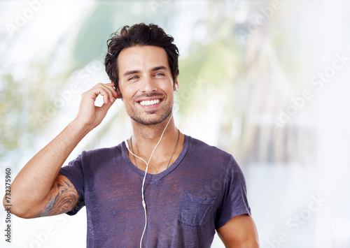 Man, fashion and smile with earphones for music, podcast or streaming online on mockup. Male person, happy and listening to audio on headphones for enjoyment, fun and wellness outdoors in nature