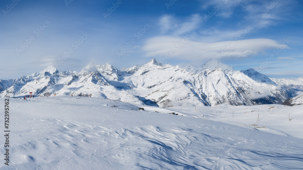 Winter mountain landscape. Wallpaper or background. Cold weather and frost. A place for skiing. Ski resort. High rocks and snow. View of mountains.