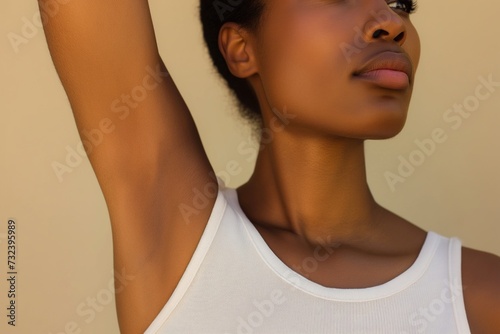 A young African American woman shows her shaved armpit. Body care concept photo