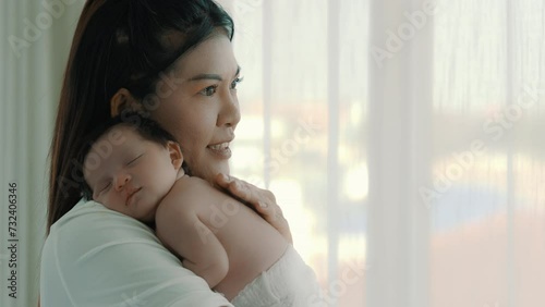 Infant or newborn baby get deep sleep Happy single mom carrying small baby on shoulder protect serene sleep taking care of health comfort safety little child Mom lull baby sleeping photo