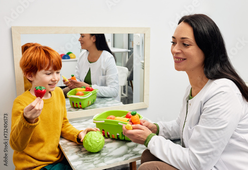Male child in session with a speech therapist. Pediatric speech and language therapy