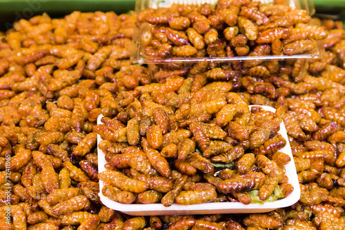 Exotic Asian food. Thai ancient cuisine. Fried insect larvae (mostly pruner, wood engraver) photo
