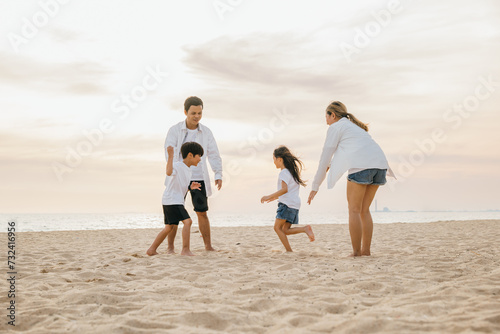 Joyful family on the beach parents and children walking playing and laughing. Summer holiday happiness carefree moments and family fun in the sun. Quality time filled with smiles and joy.