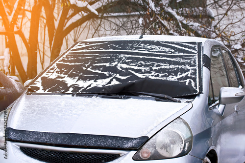 Car windshield cover from freezing winter weather including snow, frost and ice.  Frost guard windshield car cover. Windshield protector, snowcover. . photo