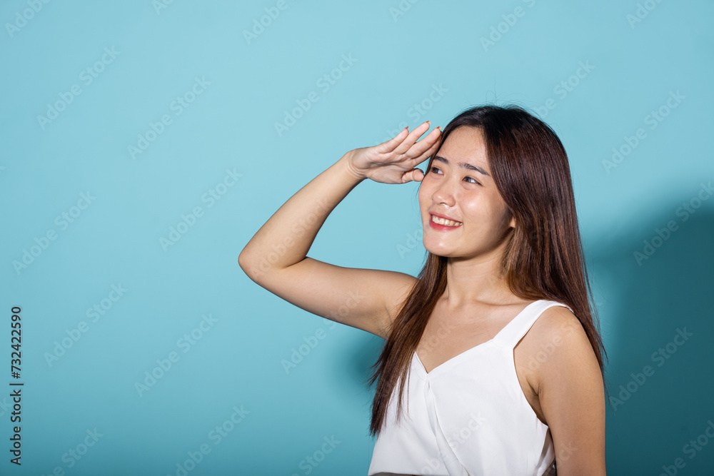 Portrait young woman hand up cover face protect sun light and UV in studio isolated on blue background, female raising arm and hand in protection and block sunshine, cosmetic sunscreen cream advertise Portrait young woman hand up cover face protect sun light and UV in studio isolated on blue background, female raising arm and hand in protection and block sunshine, cosmetic sunscreen cream advertise