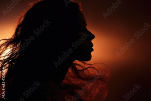 A striking silhouette of a woman with flowing long hair. Perfect for fashion, beauty, or artistic concepts