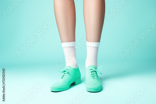 A picture of a person wearing green shoes and white socks. This versatile image can be used in various contexts
