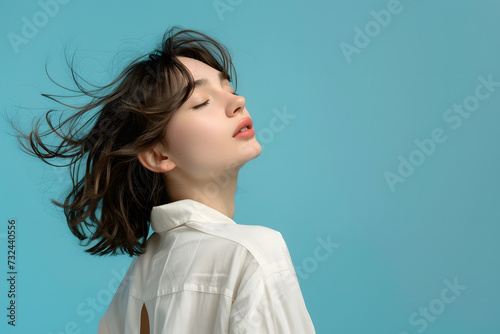 Photo of positive sweet lady dressed shirt arm cheek air blowing empty space isolated blue color background
