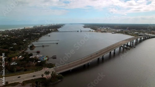 Wallpaper Mural Aerial Panning Shot Of Segmental Bridge And Belleair Causeway Over River In Residential City Under Cloudy Sky - Daytona Beach , Florida Torontodigital.ca