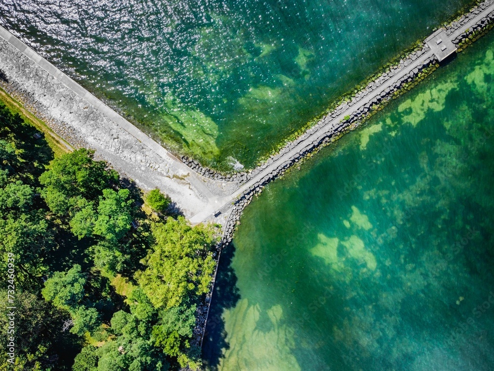 Aerial shot of a pier connected to a road stretched over an ocean
