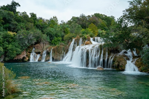 Aerial view of a majestic waterfall cascading down a rocky cliff face: Croatia
