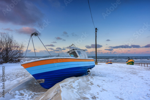 Fototapeta Naklejka Na Ścianę i Meble -  Fishing boats on the Baltic Sea beach in Jantar at winter. Poland
