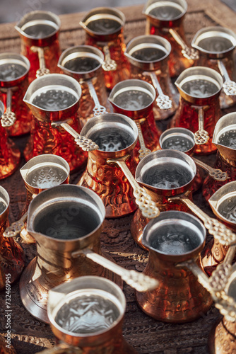 Fototapeta Naklejka Na Ścianę i Meble -  Many golden pots or kettles for Turkish coffee