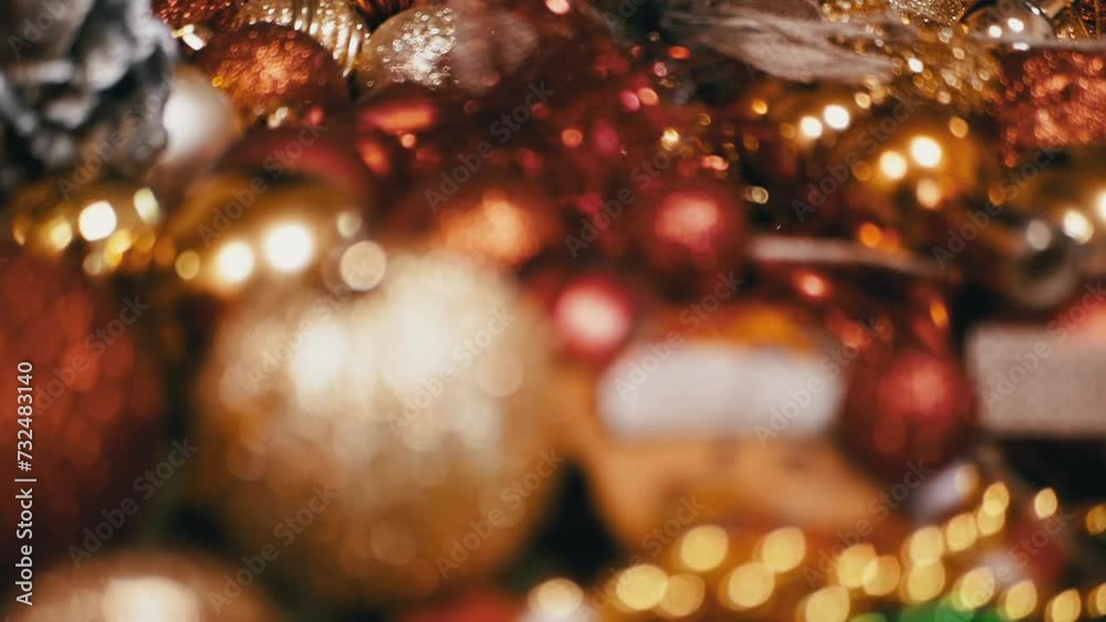 Close up, of Golden and Red Christmas Balls on a Christmas Background. Lots of sparkling bright shiny New Year's baubles. Slide shot. Blurred motion. Looping. Christmas decorations. Selective focus. Close up, of Golden and Red Christmas Balls on a Christmas Background. Lots of sparkling bright shiny New Year's baubles. Slide shot. Blurred motion. Looping. Christmas decorations. Selective focus.