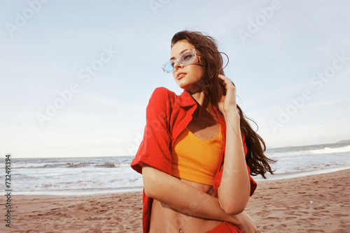 Smiling Woman at the Beach, Embracing Freedom in Colorful Sunglasses