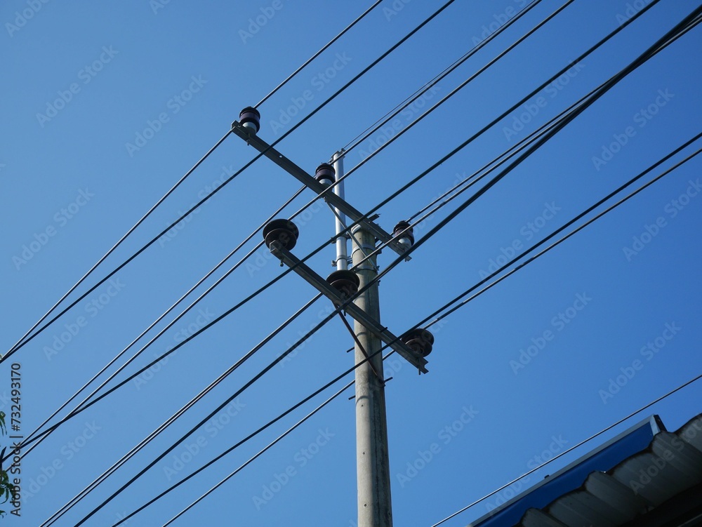 Close-up of a telephone pole with multiple electrical wires and cables attached to it Close-up of a telephone pole with multiple electrical wires and cables attached to it