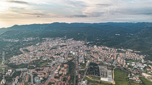 Aerial view of a town nestled in a picturesque valley  bathed in the golden light of the evening sun