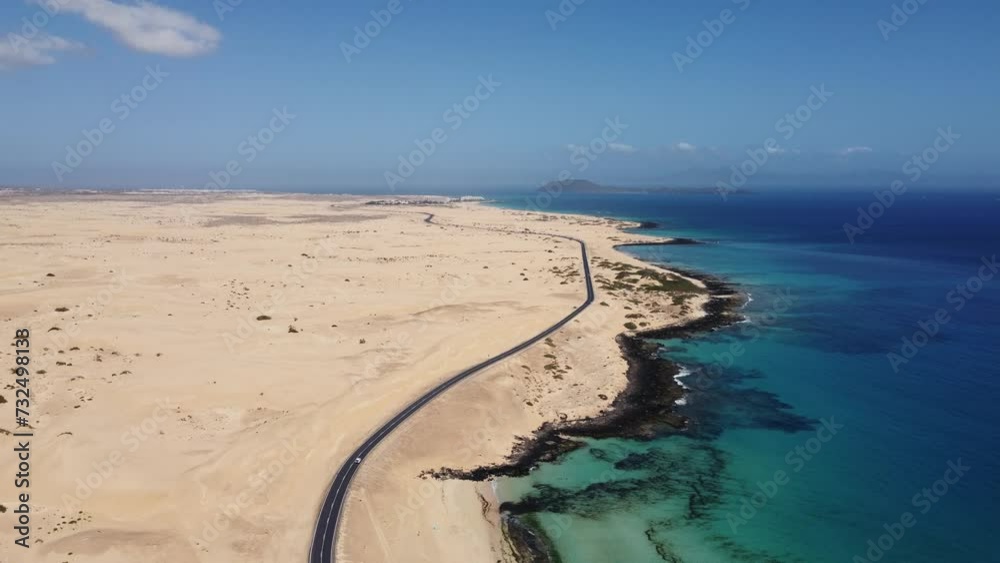 Aerial view of road crossing Corralejo Dunes Natural Park, Fuerteventura, Canary Islands, Spain. Alzada beach. Aerial view of road crossing Corralejo Dunes Natural Park, Fuerteventura, Canary Islands, Spain. Alzada beach.