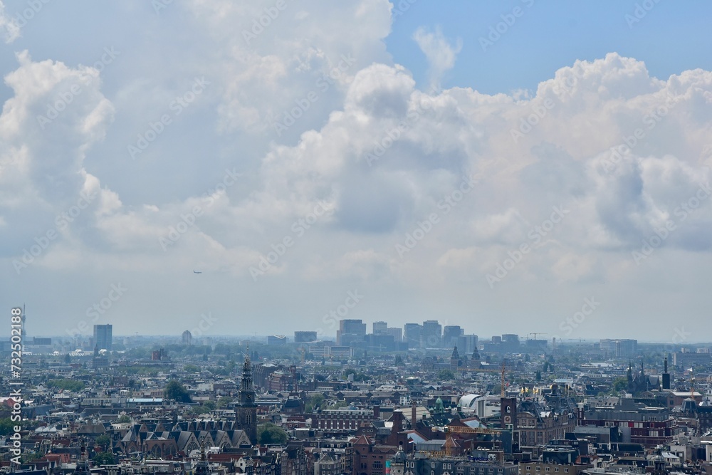 a blue sky with many clouds is in the air over a city