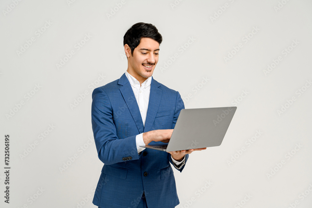 Content businessman engages with laptop, his expression one of satisfaction at the information or results displayed on the screen, perfect for themes of technology, business analytics, or remote work