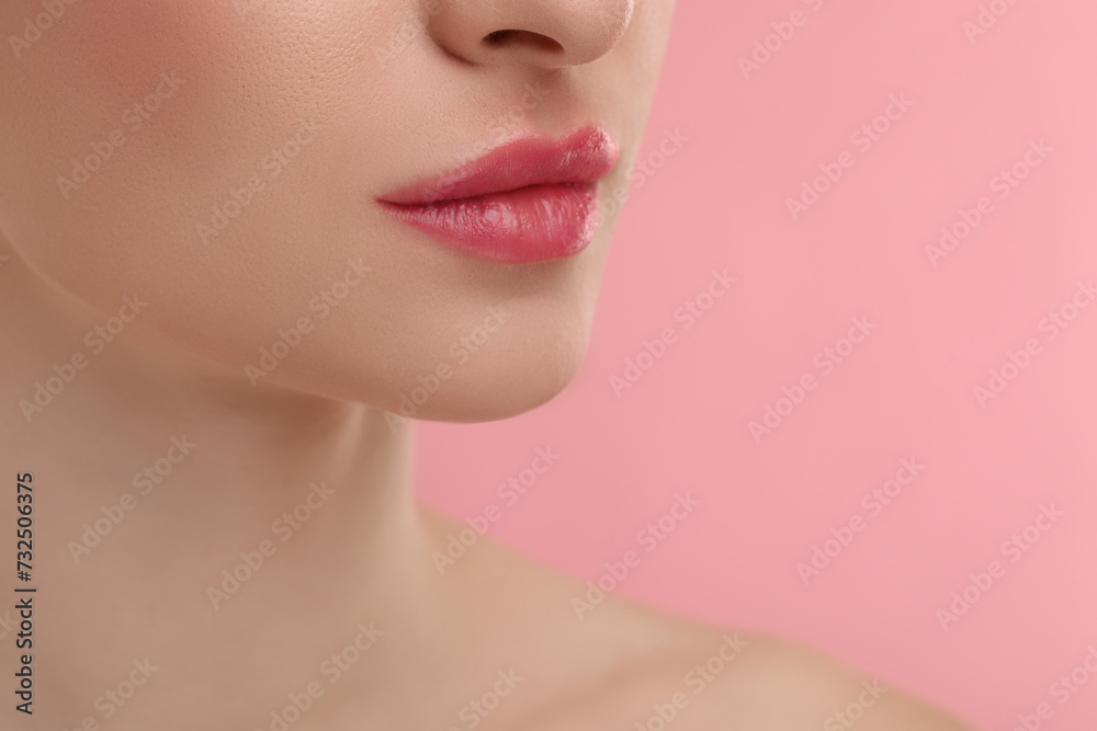 Young woman with beautiful full lips on pink background, closeup Young woman with beautiful full lips on pink background, closeup