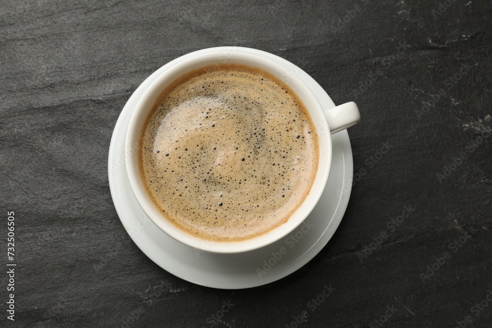 Cup of aromatic coffee on black table, top view Cup of aromatic coffee on black table, top view