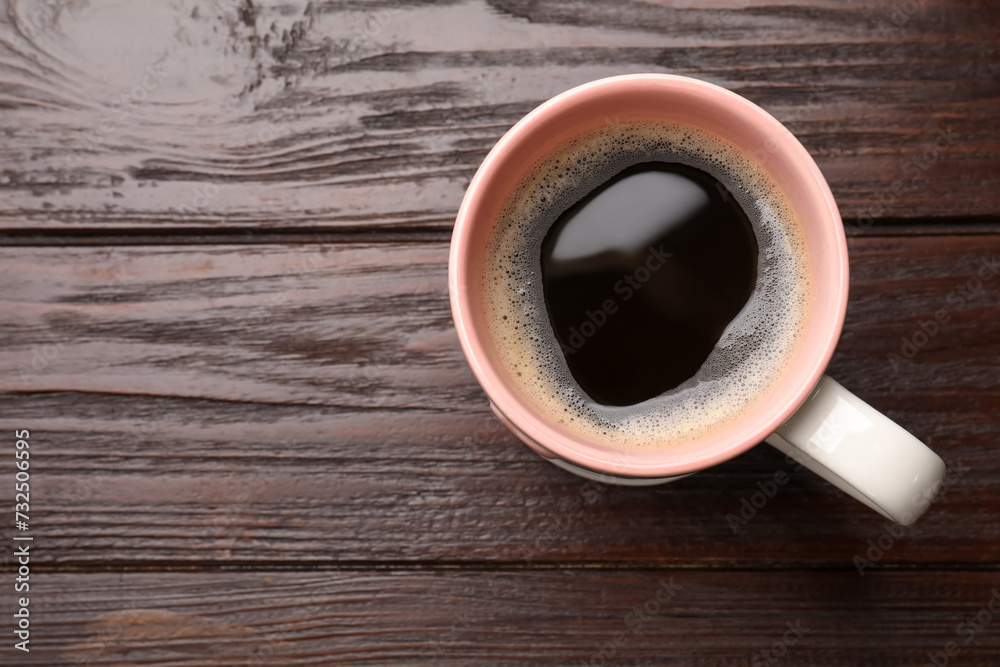 Cup of aromatic coffee on wooden table, top view. Space for text Cup of aromatic coffee on wooden table, top view. Space for text