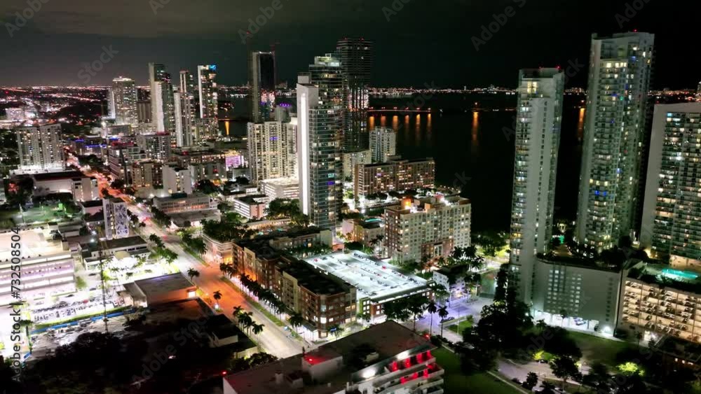 Aerial shot of illuminating Miami downtown Financial district and traffic on streets at night Aerial shot of illuminating Miami downtown Financial district and traffic on streets at night