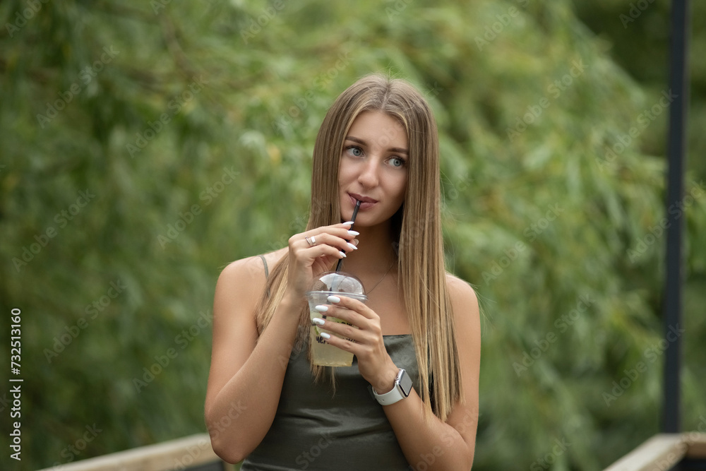 Portrait of a young beautiful blonde girl in a city summer park. Portrait of a young beautiful blonde girl in a city summer park.