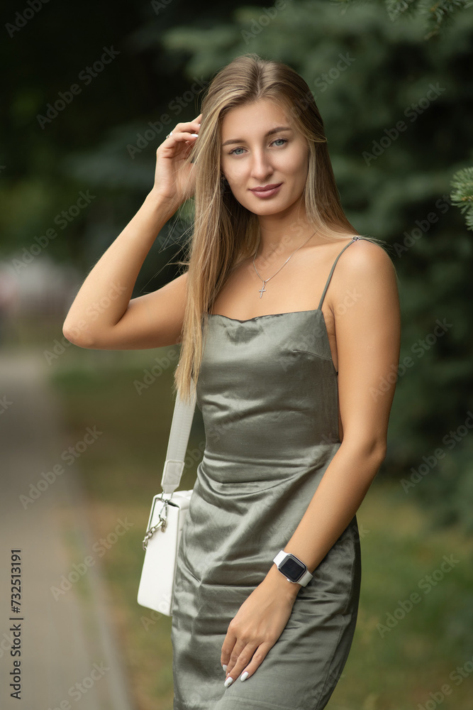 Portrait of a young beautiful blonde girl in a city summer park. Portrait of a young beautiful blonde girl in a city summer park.
