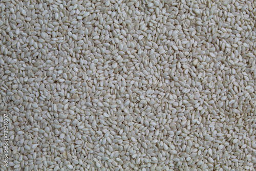 White sesame seeds as background photo
