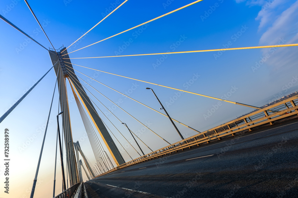 Cable-stayed bridge in the light of the morning sun and against the background of a clear blue sky. Murom. Russia. Cable-stayed bridge in the light of the morning sun and against the background of a clear blue sky. Murom. Russia.