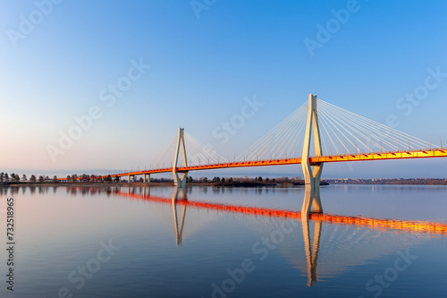 Cable-stayed bridge in the light of the morning sun and against the background of a clear blue sky. Moore. Russia.