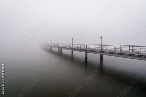Pier in Tagus river with fog - Lisbon  Portugal